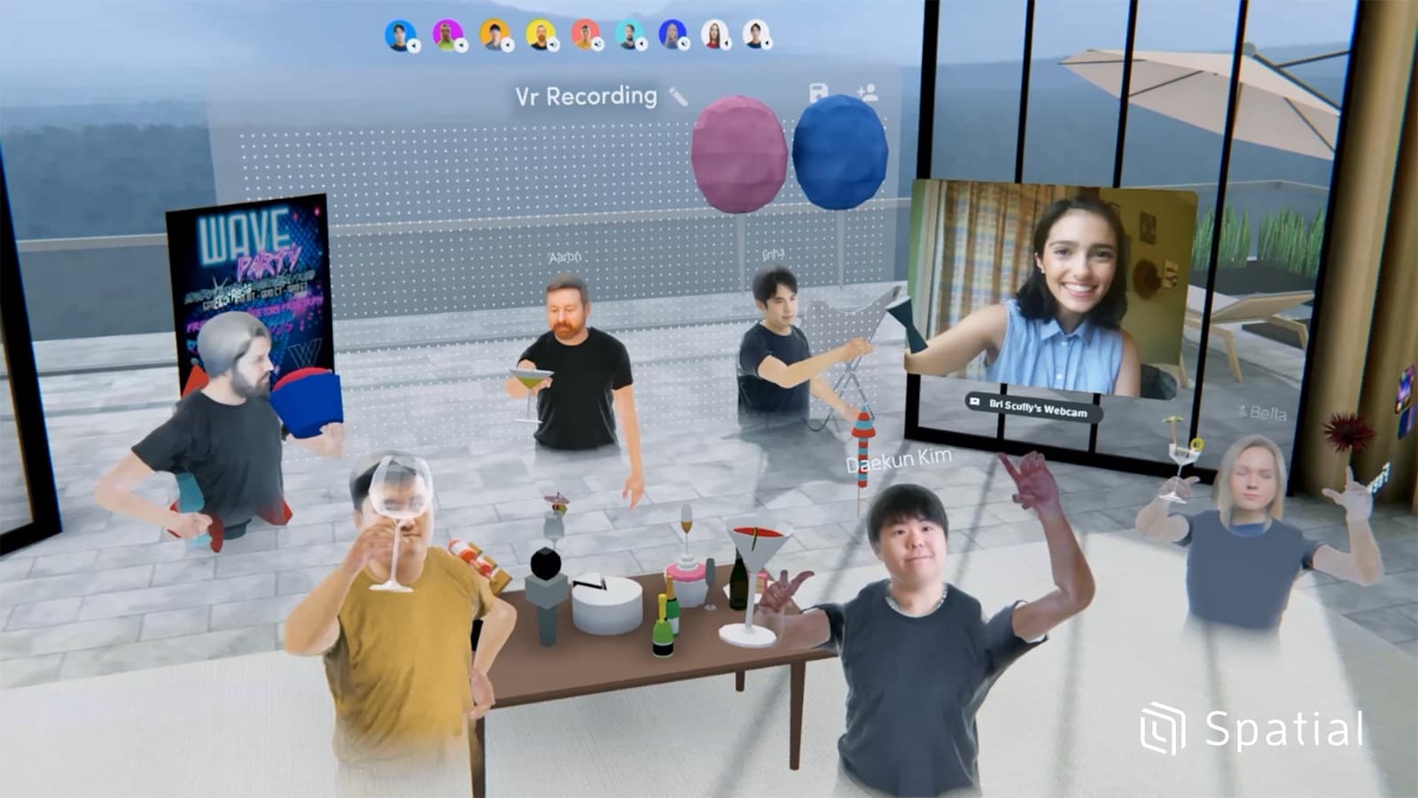 Avatars gathered around a table in a Spatial VR meeting room, with one person joining by webcam